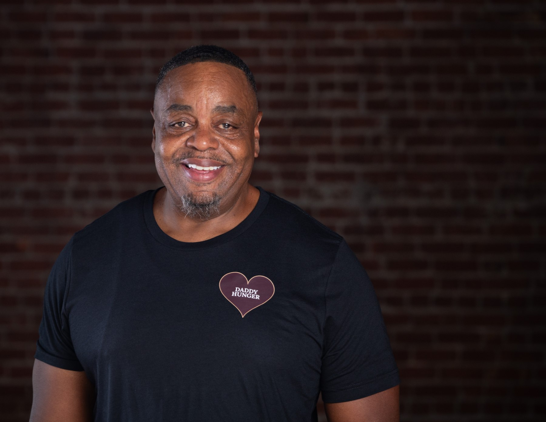 Ray Upchurch wearing a black Daddy Hunger T-shirt
