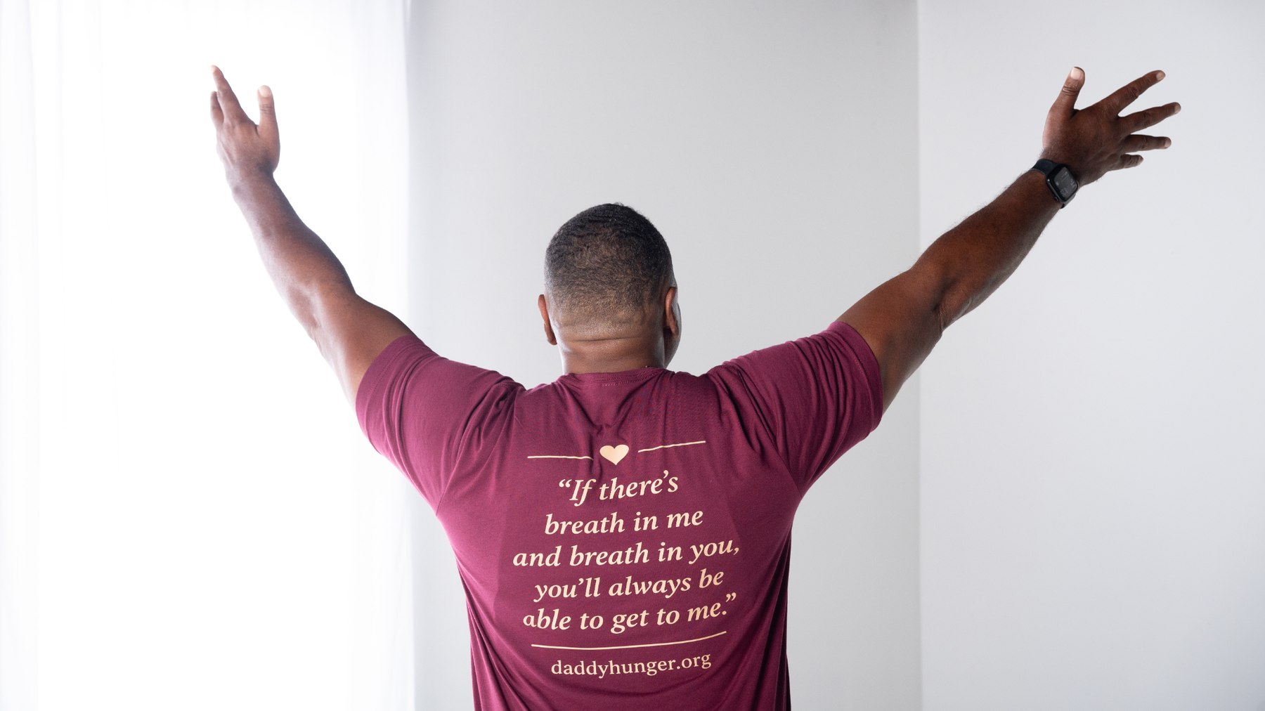 Ray Upchurch wearing the burgundy Daddy Hunger quote shirt